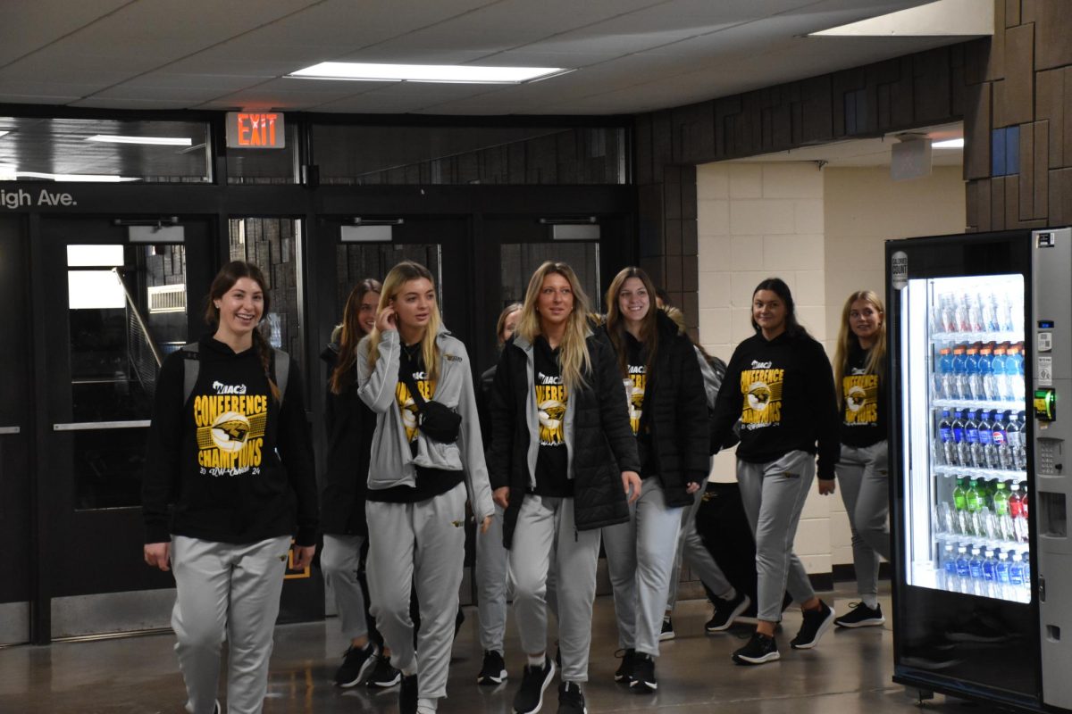 Members of the UWO volleyball team walk down the hall at Kolf Sports Center during its send off to the NCAA Elite Eight round on Dec. 2