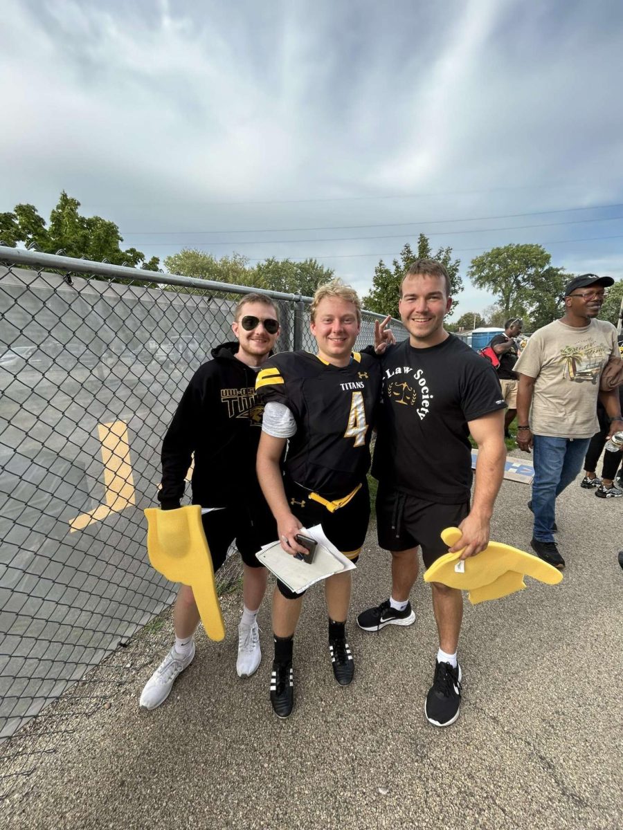 Katie Pulvermacher / Advance-Titan -- Staff writer and former Co-Sports Editor Nolan Swenson (right) celebrates a UW Oshkosh football victory with Assistant News Editor Jacob Link (middle) and News Editor Josh Lehner (left).