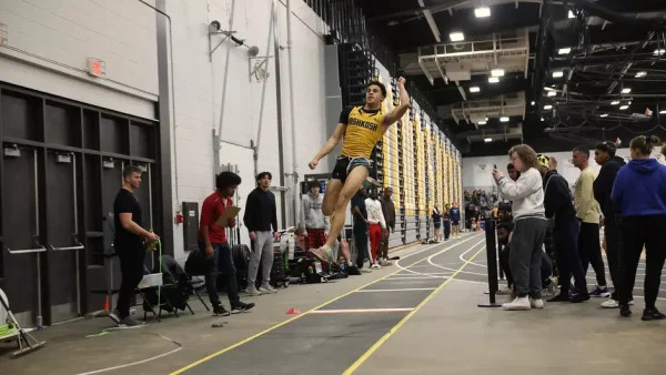 Courtesy of Steve Frommell / UWO Athletics -- UWO junior Joshua Rivers takes flight in the long jump at the Kolf Sports Center Dec. 7.