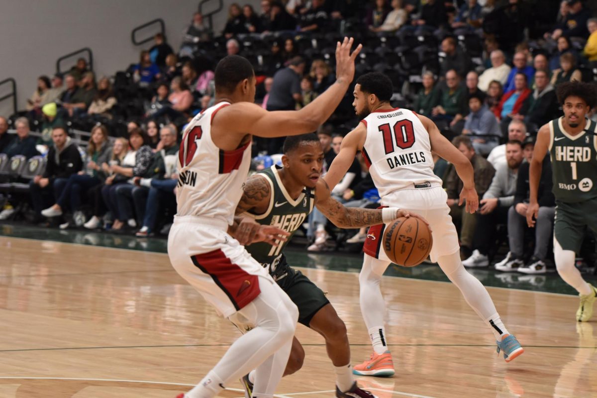 Jacob Link / Advance-Titan -- The Herd's James Akinjo drives to the basket in a game earlier this season at the Oshkosh Arena.