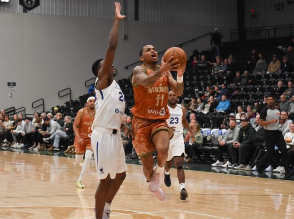 Jacob Link / Advance-Titan -- The Herd's James Akinjo takes flight in Wisconsin's 128-114 win over Delaware Wednesday at the Oshkosh Arena.