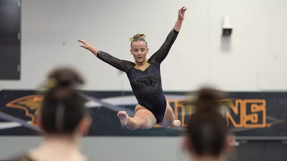 Courtesy of Terri Cole / UWO Athletics -- Jay Ratkowski performs on the balance beam in a meet earlier this season at the Kolf Sports Center.