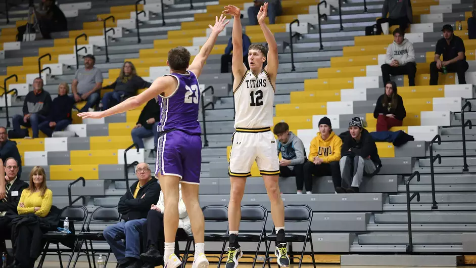 Courtesy of Steve Frommell / UWO Athletics -- Oshkosh's Jonah Rindfleisch attempts a 3-pointer against UW-Whitewater earlier this season at the Kolf Sports Center.