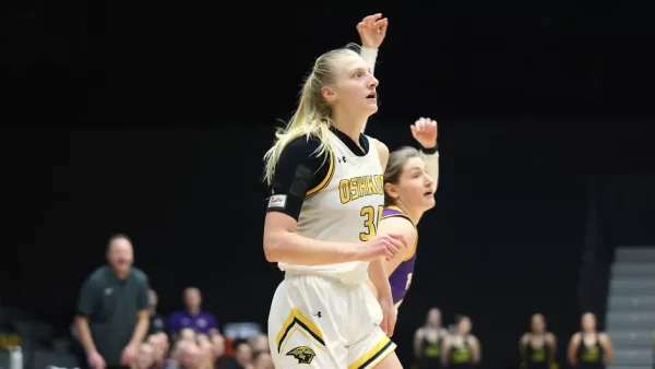 Courtesy of Steve Frommell / UWO Athletics -- Oshkosh's Kayce Vaile posts up on a Stevens Point defender Wednesday at the Kolf Sports Center.