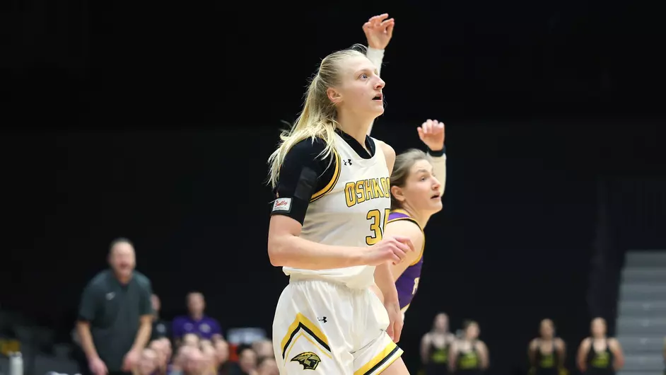 Courtesy of Steve Frommell / UWO Athletics -- Oshkosh's Kayce Vaile posts up on a Stevens Point defender Wednesday at the Kolf Sports Center.