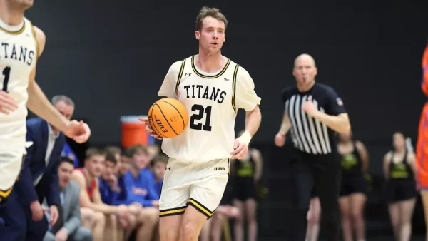 Courtesy of Steve Frommell / UWO Athletics -- Oshkosh's Carter Thomas brings the ball up the court for the Titans against UW-Platteville Wednesday night.