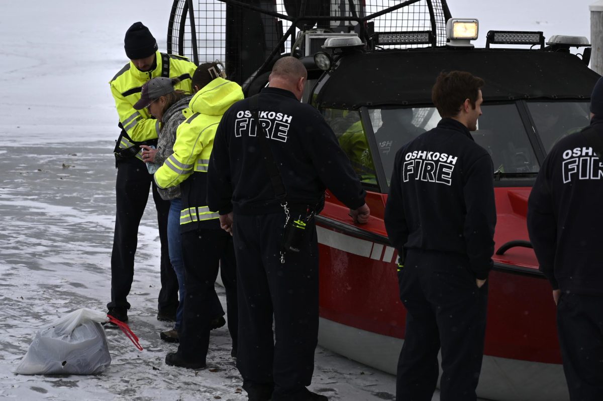 Jess Duch / Advance-Titan -- Rescue crews help a woman back onto land on an airboat after the truck she was in crashed through the ice on Lake Winnebago Saturday.