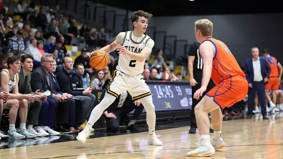 Courtesy of Steve Frommell / UWO Athletics -- Oshkosh's Joey LaChapell crosses over against a UW-Platteville defender in a game earlier this season at the Kolf Sports Center.