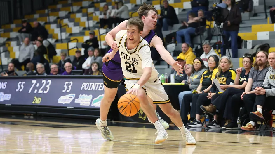 Courtesy of Steve Frommell / UWO Athletics -- Oshkosh's Carter Thomas drives to the basket against UWSP Wednesday night.