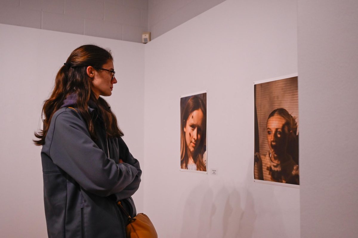 Photos by Jessica Duch / Advance-Titan -- UWO student Elizabeth Tisler pauses to appreciate fellow student Hannah Detert’s artwork titled, ‘The Sun Doesn’t Shine Without You.’