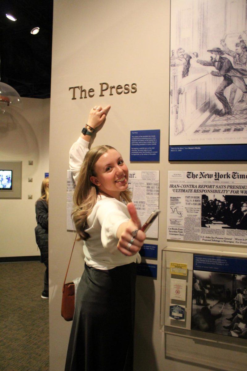 Courtesy of Katie Pulvermacher (‘23) -- Anya Kelley poses with iconic newspapers at the National Museum of American history during a CMA conference in Washington D.C.