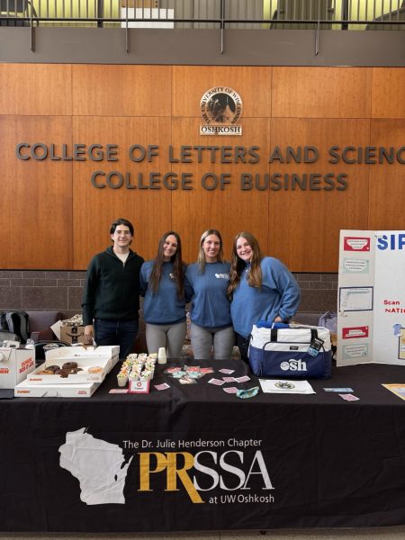 PRSSA's NODAC campaign team poses for a photo in front of their set up. 