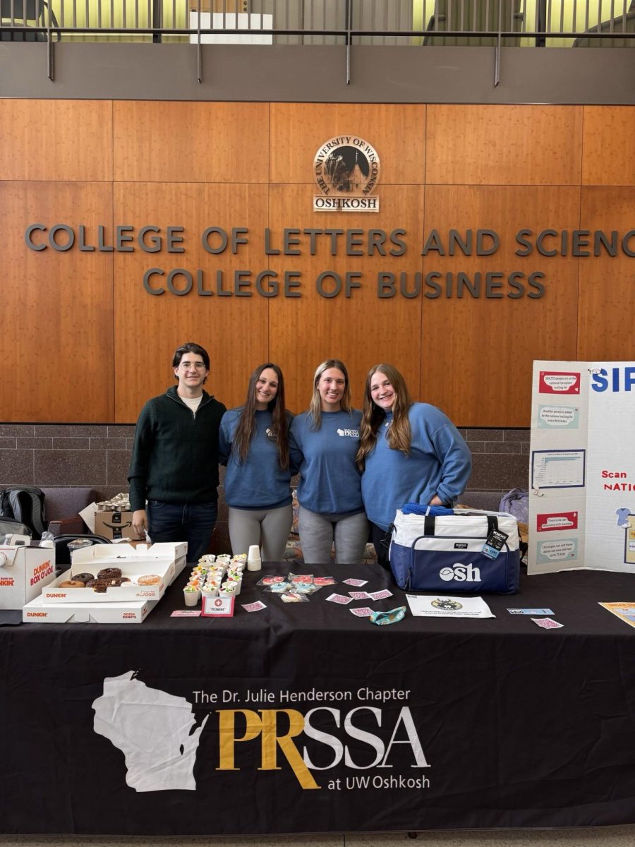 PRSSA's NODAC campaign team poses for a photo in front of their set up.