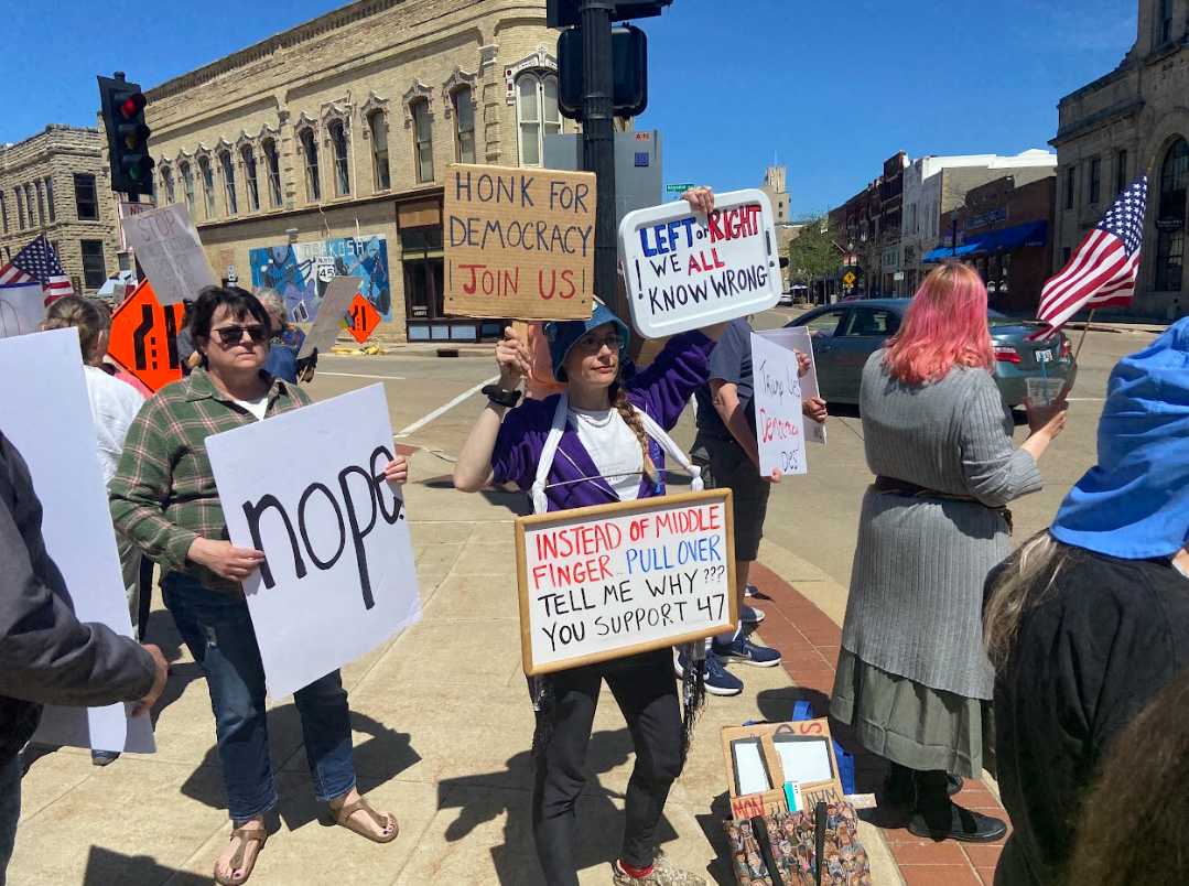 Cassidy Johnson / Advance-Titan -- Protestors gathered by the sun dial downtown carrying both anti-Trump and pro-democracy signs.