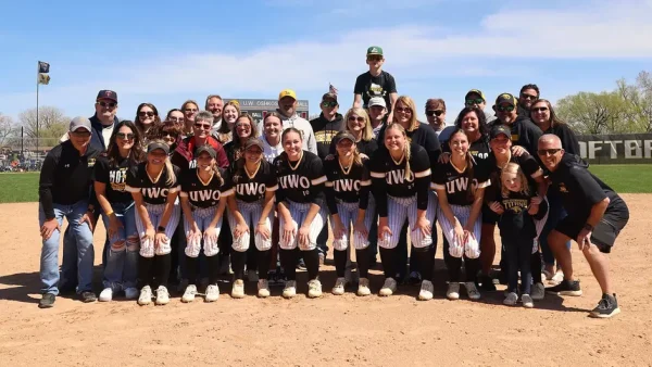 Courtesy of Steve Frommell / UWO Athletics -- The seniors of the UW Oshkosh softball team pose with their families after the Titans swept UW-Eau Claire on Sunday.