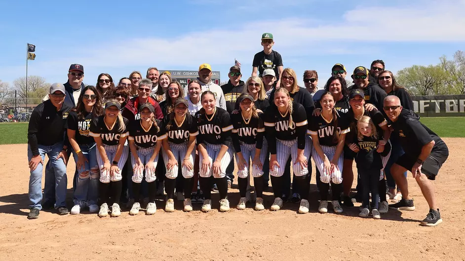 Courtesy of Steve Frommell / UWO Athletics -- The seniors of the UW Oshkosh softball team pose with their families after the Titans swept UW-Eau Claire on Sunday.
