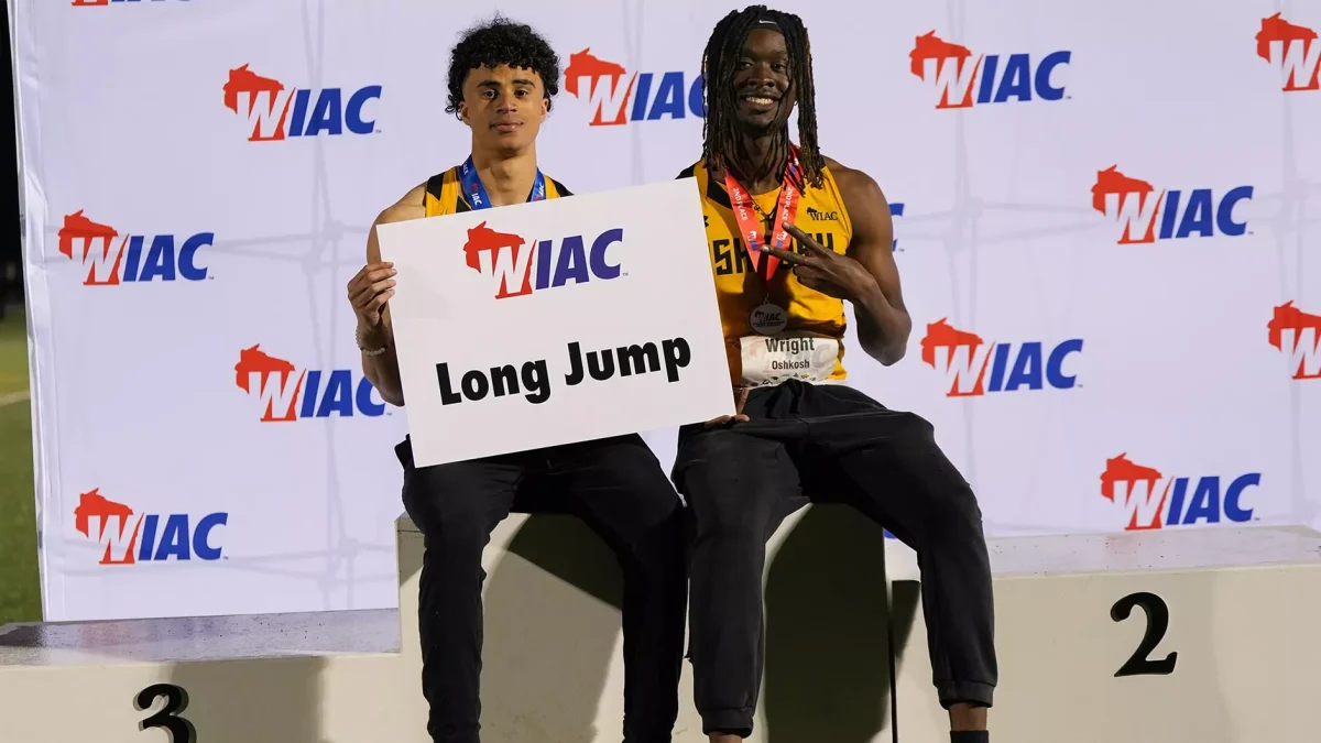 Courtesy of Terri Cole / UWO Athletics -- UWO's Josh Rivers (left) and Caleb Wright (right) celebrate first and second place finishes in the men's long jump event at the WIAC championships.