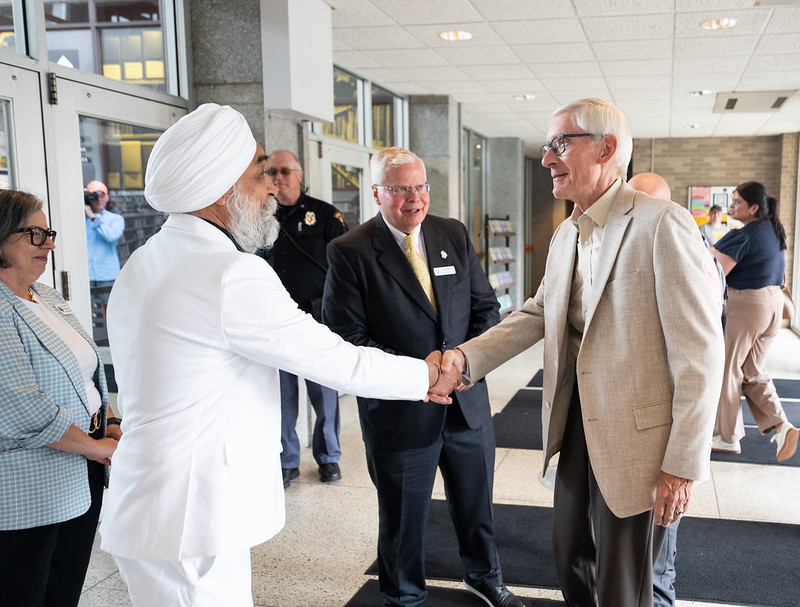 Courtesy of UWO / UWO Chancellor Manohar Singh, left, greets Gov. Tony Evers, right, and Universities of Wisconsin President Jay Rothman, center, Tuesday morning before a tour of Polk Library.