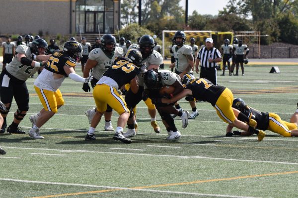Zach Bellin / Advance-Titan – UWO’s Michael Wind (95) and Jake Shutter (7) attempt to tackle Lakers running back Cam Davis (22). The Titans defense held Davis to 56 rushing yards in the 38-21 win.
