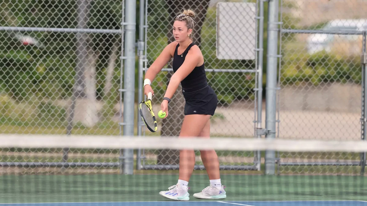Courtesy of Steve Frommell / UWO Athletics – Jameson Gregory prepares to serve against St. Norbert College en route to a victory in the doubles competition as part of the Titans’ sweep