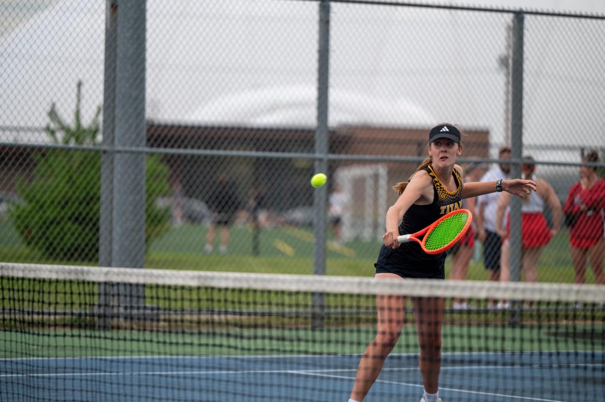 Jess Duch / Advance-Titan – UWO’s Bre Schultz volleys the ball over the net in a match earlier this season at the Kolf Sports Center Outdoor Tennis Courts.