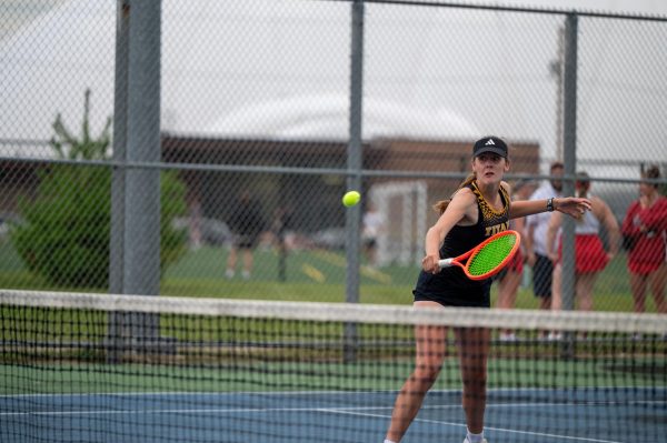 Jess Duch / Advance-Titan – UWO’s Bre Schultz volleys the ball over the net in a match earlier this season at the Kolf Sports Center Outdoor Tennis Courts.