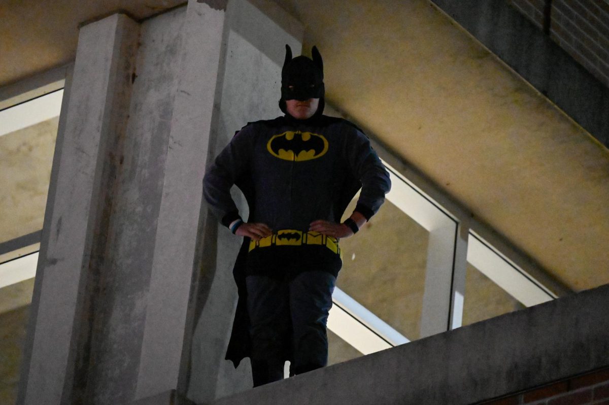 Jess Duch / Advance-Titan – The “UWO Batman” perches on top of the university’s parking garage on High Avenue.