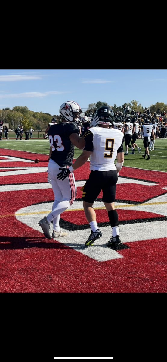 Nolan Andler / Advance-Titan – Kyle Scharenbach (9) chats with UW-River Falls wide receiver Andy Groebner (83) in the end zone before the Falcons took home a 27-24 victory on Oct. 8, 2022.