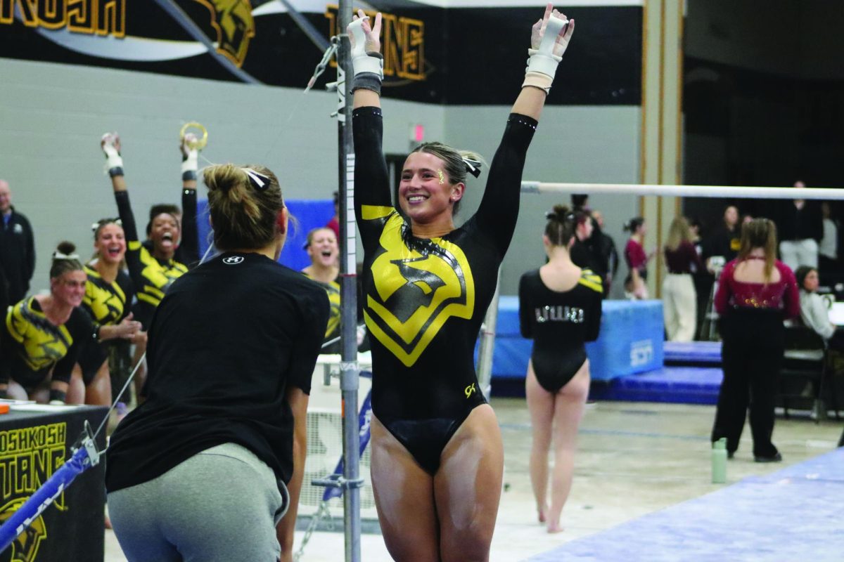 Katie Lechton / Advance-Titan --
Averie Evans smiles as she finishes her routine on the uneven bars in the Titans’ home dual against Hamline University (Minnesota) on Jan. 15th.
