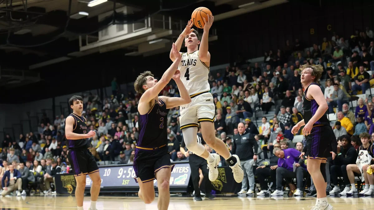 Courtesy of Steve Frommell / UWO Athletics -
Michael Metcalf-Grassman drives to the hoop against a defender in a game against UW-Stevens Point on Feb. 21.