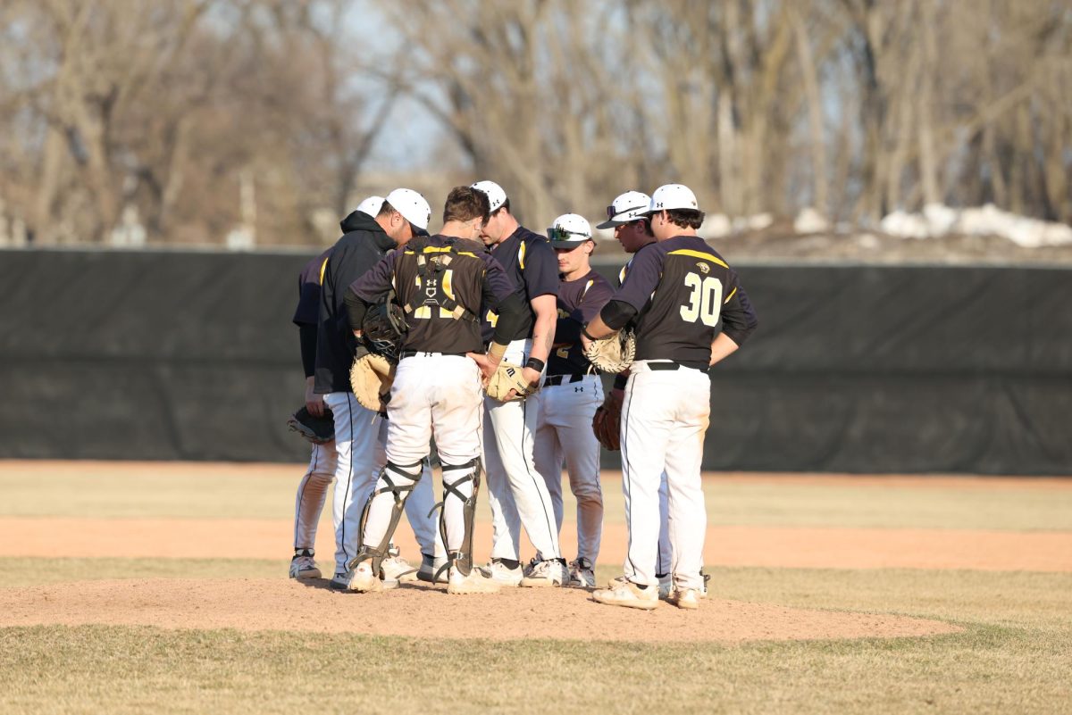 Courtesy of Steve Frommell / UWO Athletics – Members of the UW-Oshkosh baseball team meet on the mound during their game against UW-Eau Claire on March 29.