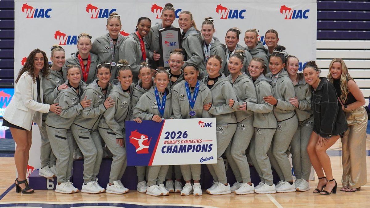 Courtesy of the Wisconsin Intercollegiate Athletic Conference -
UWO gymnastics poses for a photo with the 2026 WIAC championship trophy and signage on March 7.