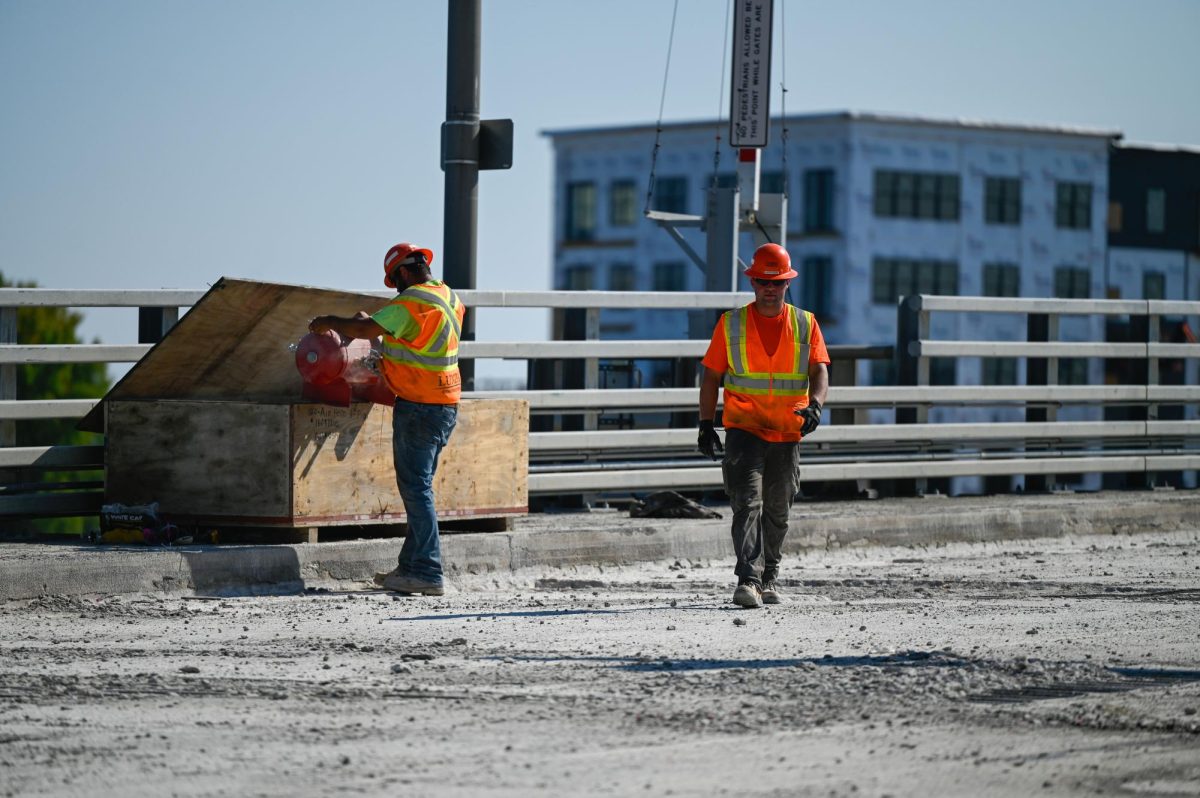 Jess Duch / Advance-Titan -- Construction crews work on the Main Street bridge in Oshkosh.
