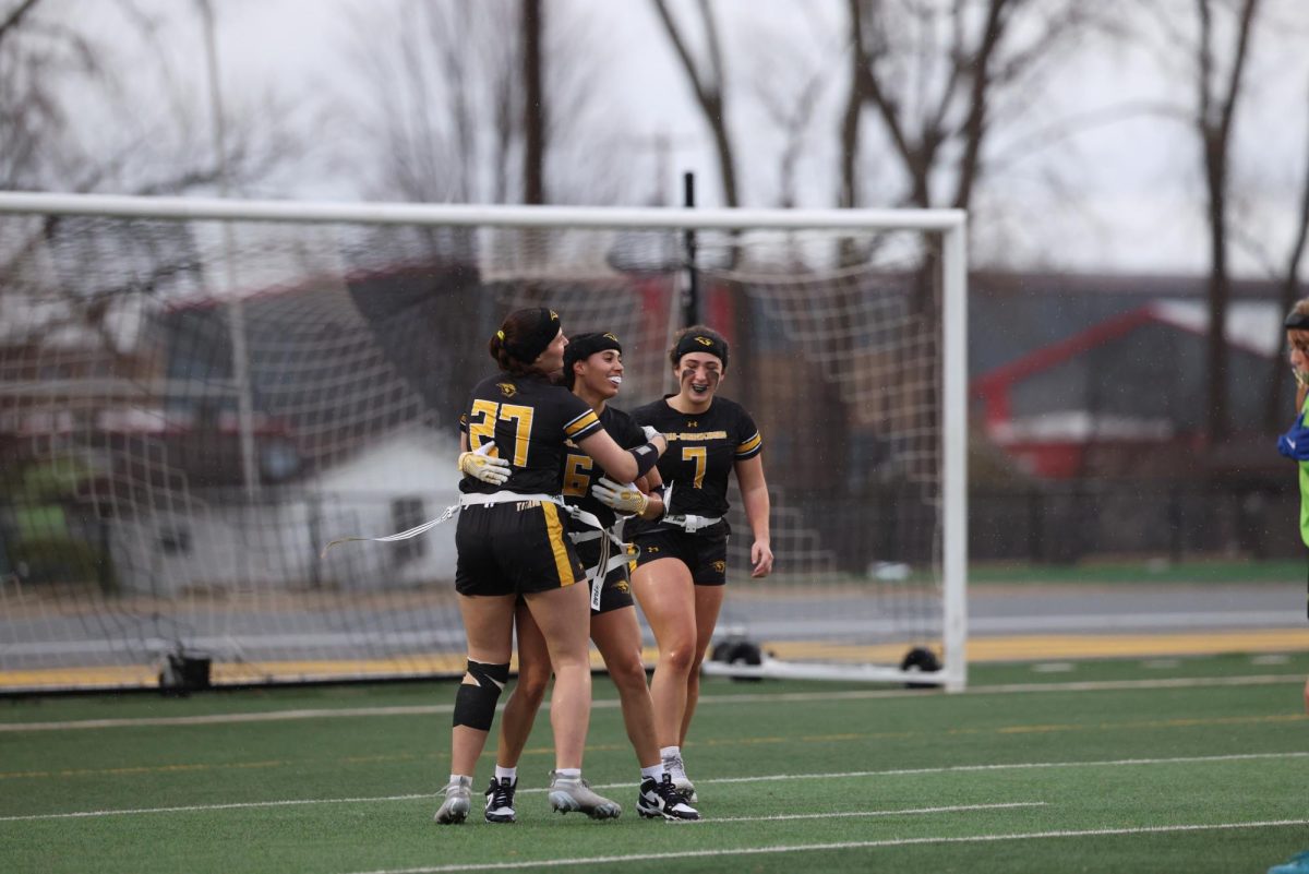 Courtesy of Steve Frommell / UWO Athletics -- Kyana Williams (center) celebrates with Aaliyah Lathrop (right) and Sophia Lee (left) after scoring a touchdown against Bryant & Stratton College on April 12.  
