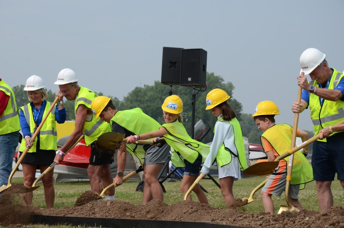 Vladyslav Plyaka / Advance-Titan -- EAA volunteers and staff participate in the Discovery Park groundbreaking ceremony on the opening day of AirVenture 2026.  