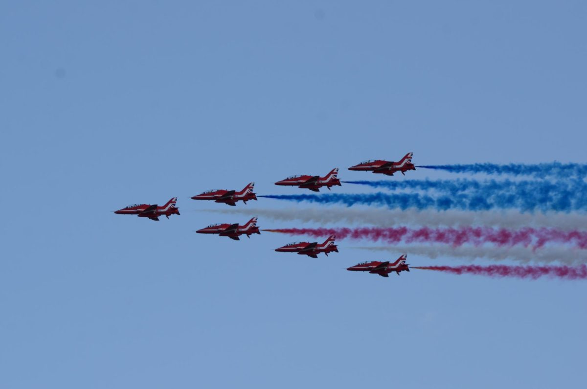 Vladyslav Plyaka / Advance-Titan --- The Red Arrows aerobatic team flies over the EAA AirVenture 2026, leaving red, white and blue smoke trails behind them on Wednesday, July 22.